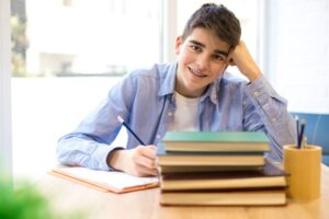 Teen boy with braces doing his homework